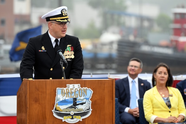 Cmdr. Lacy Lodmell, commanding officer of the Virginia-class fast attack submarine USS Oregon (SSN 793), delivers remarks during a commissioning ceremony in Groton, Connecticut May 28, 2022