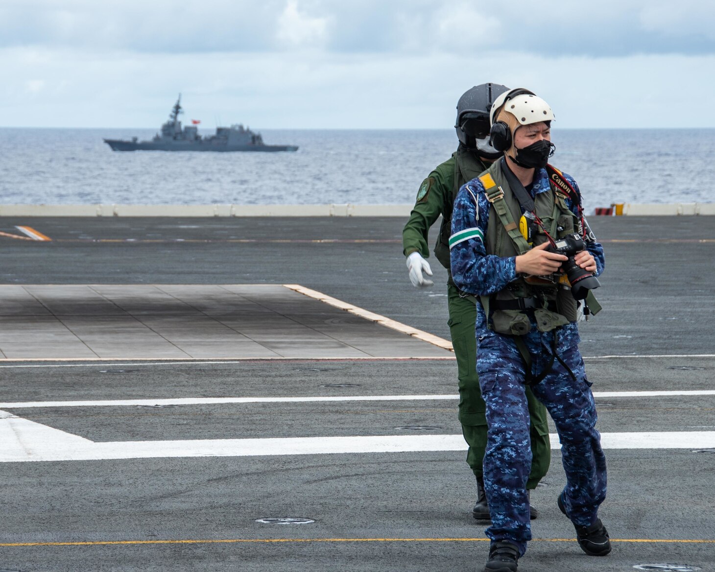 220526-N-BR419-1089 PHILIPPINE SEA (May 26, 2022) Sailors attached to the Japan Maritime Self-Defense Force (JMSDF) destroyer JS Teruzuki (DD 116) take photos on the flight deck of the U.S. Navy’s only forward-deployed aircraft carrier USS Ronald Reagan (CVN 76). The U.S. Navy and JMSDF routinely conduct naval exercises together, strengthening the U.S.-Japan alliance and maintaining a free and open Indo-Pacific region. Ronald Reagan, the flagship of Carrier Strike Group 5, provides a combat-ready force that protects and defends the United States, and supports alliances, partnerships and collective maritime interests in the Indo-Pacific region. (U.S. Navy photo by Mass Communication Specialist 3rd Class Oswald Felix Jr.)