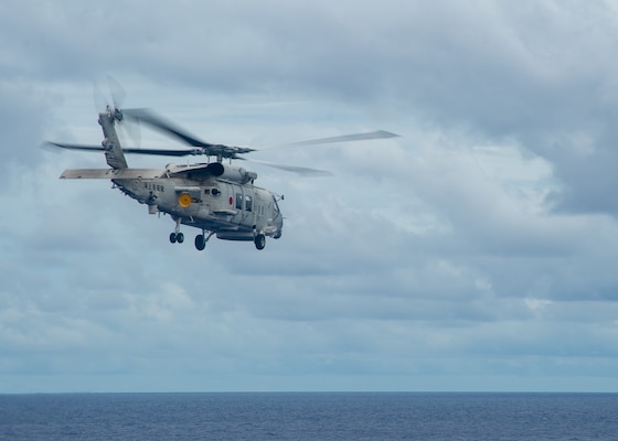 220526-N-YQ181-2046 PHILIPPINE SEA (May 26, 2022) A Japan Maritime Self-Defense Force (JMSDF) SH-60K Sea Hawk helicopter attached to the JMSDF destroyer JS Teruzuki (DDG 116) departs from the flight deck of U.S. Navy’s only forward-deployed aircraft carrier USS Ronald Reagan (CVN 76). The U.S. Navy and JMSDF have worked together as maritime partners for more than 60 years supporting the U.S.-Japan alliance. Ronald Reagan, the flagship of Carrier Strike Group 5, provides a combat-ready force that protects and defends the United States, and supports alliances, partnerships and collective maritime interests in the Indo-Pacific region. (U.S. Navy photo by Mass Communication Specialist 2nd Class Askia Collins)
