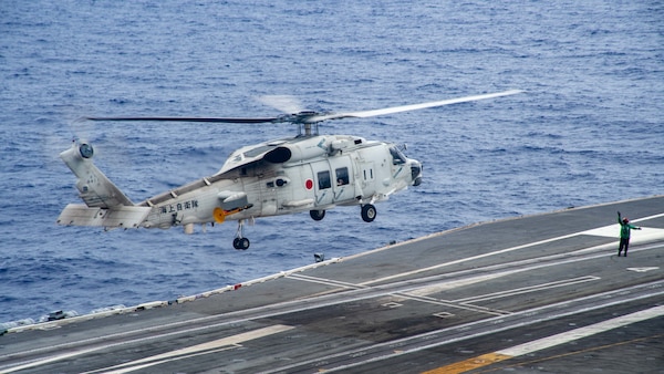 220526-N-YQ181-2019 PHILIPPINE SEA (May 26, 2022) A Japan Maritime Self-Defense Force (JMSDF) SH-60K Sea Hawk helicopter attached to the JMSDF destroyer JS Teruzuki (DDG 116) lands aboard the U.S. Navy’s only forward-deployed aircraft carrier USS Ronald Reagan (CVN 76). The U.S. Navy and JMSDF have worked together as maritime partners for more than 60 years supporting the U.S.-Japan alliance. Ronald Reagan, the flagship of Carrier Strike Group 5, provides a combat-ready force that protects and defends the United States, and supports alliances, partnerships and collective maritime interests in the Indo-Pacific region. (U.S. Navy photo by Mass Communication Specialist 2nd Class Askia Collins)