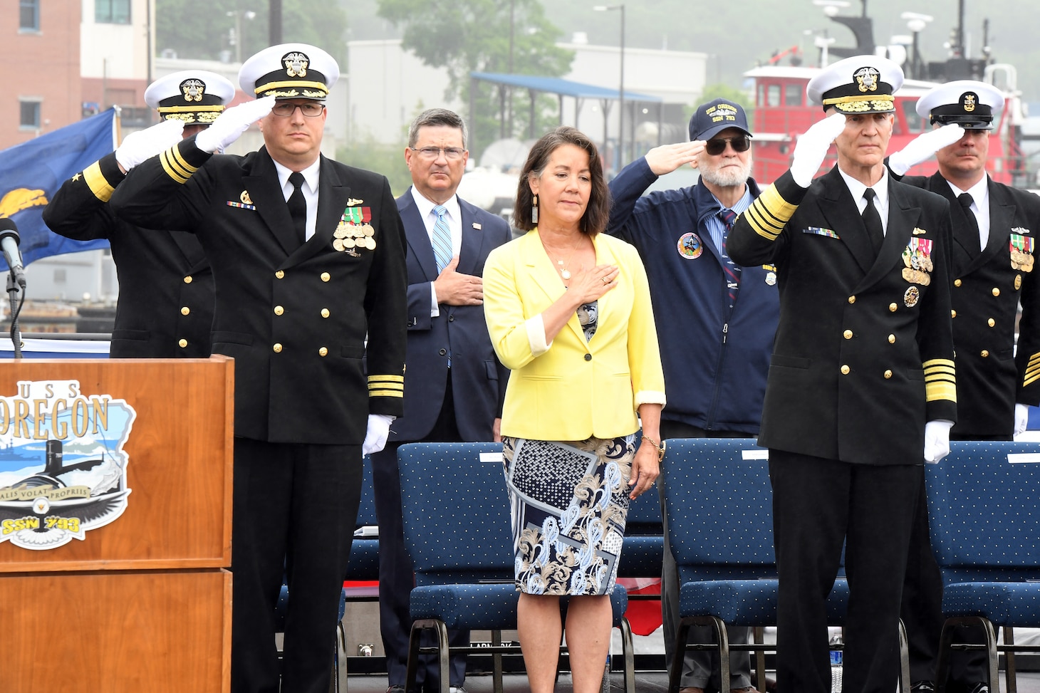 Dana Richardson, ship sponsor for the Virginia-class submarine USS Oregon (SSN 793), honors the colors alongside Oregon’s commanding officer Cmdr. Lacy Lodmell, and Adm. Frank Caldwell, director of the Naval Nuclear Propulsion Program, during a commissioning ceremony in Groton, Conn., May 28, 2022.