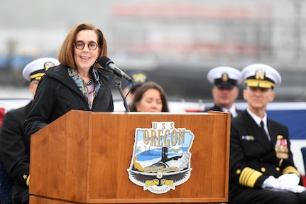 Gov. Kate Brown of Oregon delivers remarks during a commissioning ceremony for the Virginia-class fast attack submarine USS Oregon (SSN 793) in Groton, Conn., May 28, 2022.