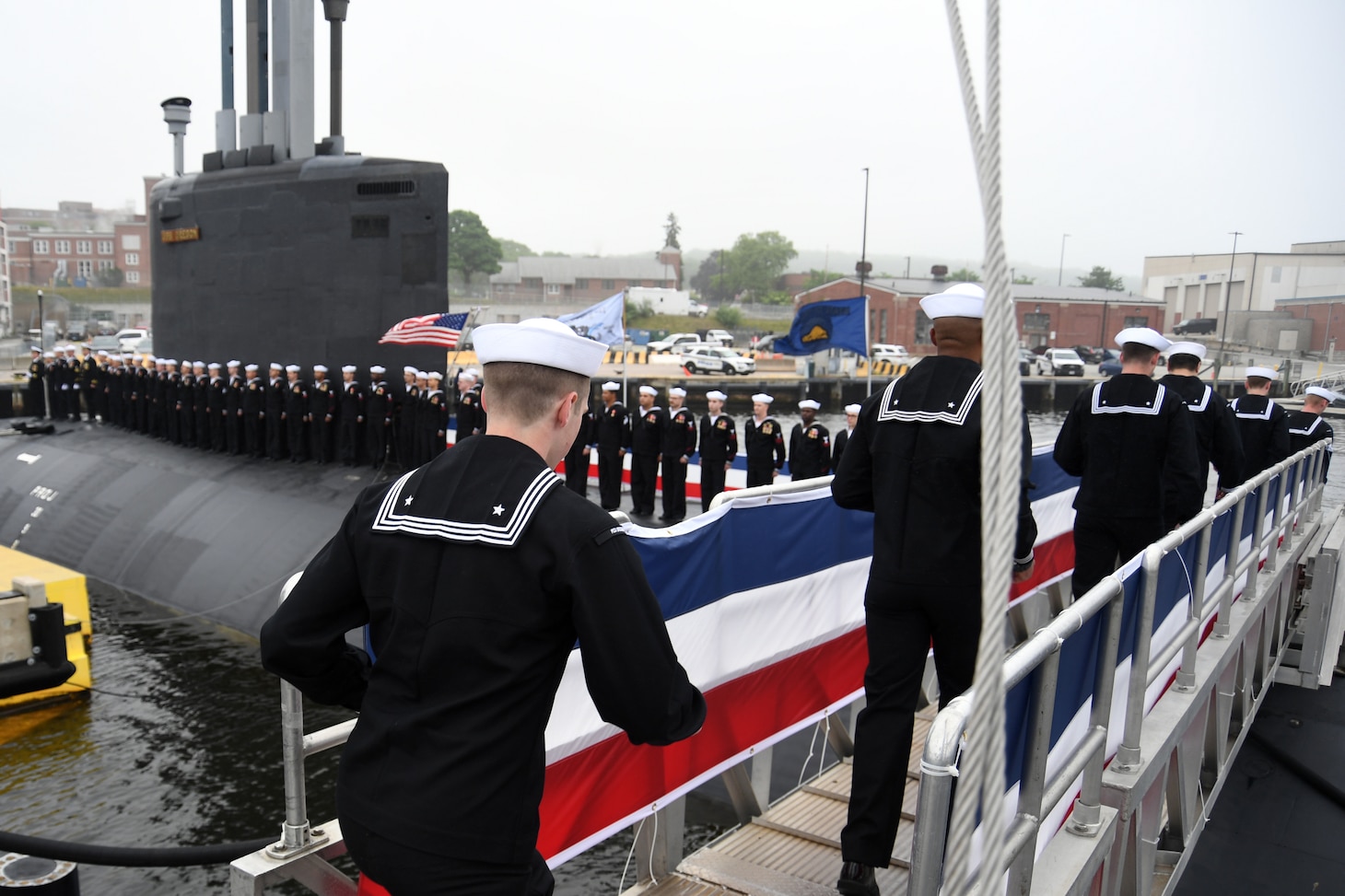 Crewmembers attached to the Virginia-class fast attack submarine USS Oregon (SSN 793) run aboard to “bring the ship to life” during a commissioning ceremony in Groton, Conn., May 28, 2022.