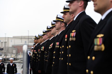 Crewmembers attached to the Virginia-class fast attack submarine USS Oregon (SSN 793) man the brow during a commissioning ceremony in Groton, Conn., May 28, 2022.