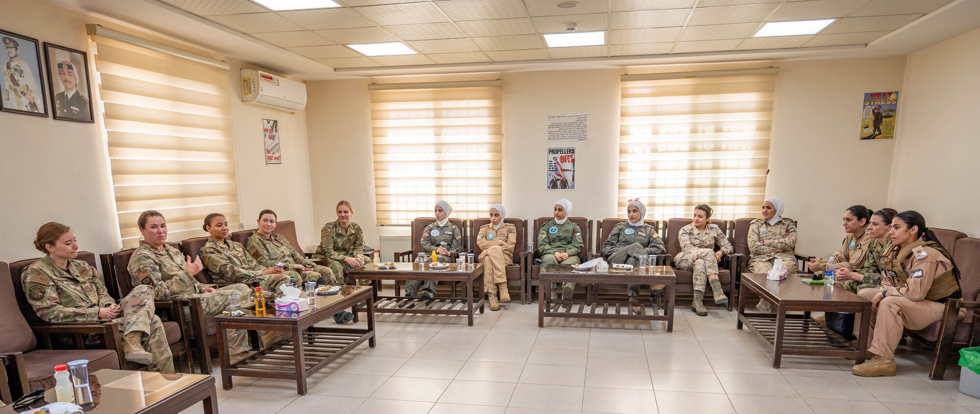 Female members of the Royal Jordanian and U.S. Air Forces talk about shared goals in their chosen profession during a visit at King Abdullah II Air Base, Jordan on March 30, 2022. The RJAF Unified Helicopter Command hosted a combat search and rescue exercise demonstration followed by static aircraft tours and a group lunch. The engagement is part of an ongoing partnership between the two countries focused on empowering women in aviation as a way to cultivate and strengthen relationships. (U.S. Air Force photo by Master Sgt. Kelly Goonan)