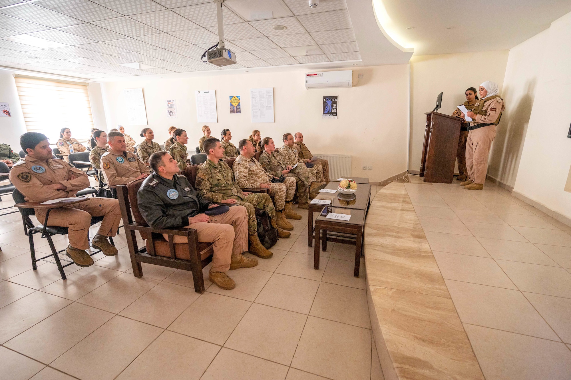 Two female Royal Jordanian Air Force UH-60 Black Hawk pilots provide a mission brief to RJAF and U.S. Air Force visitors March 30, 2022, at King Abdullah II Air Base, Jordan. The RJAF Unified Helicopter Command hosted a combat search and rescue exercise demonstration followed by static aircraft tours and group lunch. The engagement is part of an ongoing partnership between the two countries focused on empowering women in aviation as a way to cultivate and strengthen relationships. (U.S. Air Force photo by Master Sgt. Kelly Goonan)