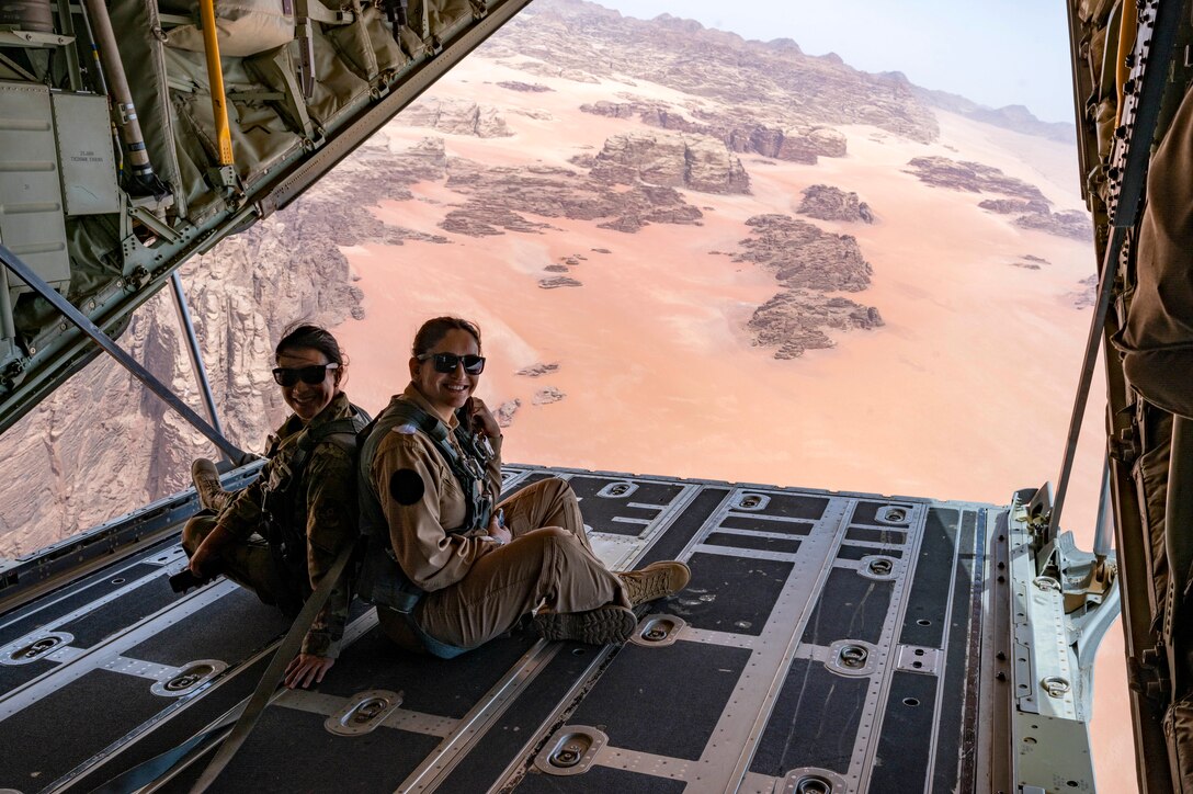 Major Lisa Wong, 332d Air Expeditionary Wing chief of staff, and Lieutenant Marah Almomani, Royal Jordanian Air Force Unified Helicopter Command Squadron 8 UH-60 Black Hawk pilot, pose for a photo on the ramp of a HC-130J Combat King II aircraft on May 16, 2022, during a low-level mission over outlying areas of Wadi Rum, Jordan. The engagement is part of an ongoing partnership between the two countries focused on empowering women in aviation as a way to cultivate and strengthen relationships. (U.S. Air Force photo by Master Sgt. Kelly Goonan)