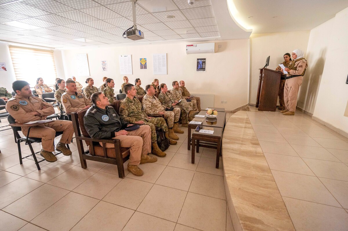 Two female Royal Jordanian Air Force UH-60 Black Hawk pilots provide a mission brief to RJAF and U.S. Air Force visitors March 30, 2022, at King Abdullah II Air Base, Jordan. The RJAF Unified Helicopter Command hosted a combat search and rescue exercise demonstration followed by static aircraft tours and group lunch. The engagement is part of an ongoing partnership between the two countries focused on empowering women in aviation as a way to cultivate and strengthen relationships. (U.S. Air Force photo by Master Sgt. Kelly Goonan)