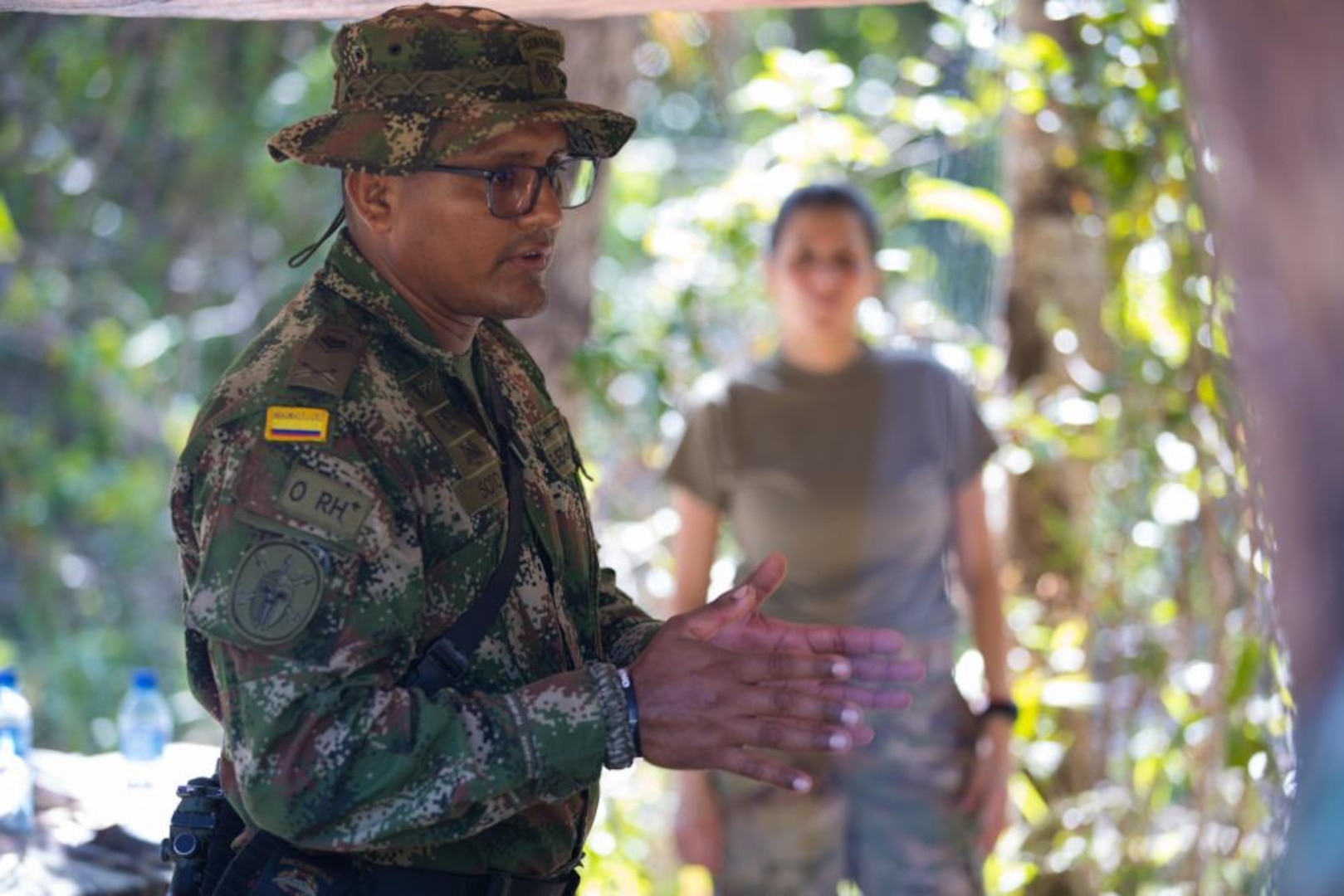 1st Cpl. Vladimir Soto, Colombian Special Forces, shares his experience about the importance of gender perspectives with U.S. Air Force Duilia Turner, lead trainer from U.S. Southern Command's Women, Peace, Safety team, during training May 10, 2022 at Manatee training site in Belize as part of TRADEWINDS22. The SOUTHCOM’s Women, Peace, and Security (WPS) Program recognizes the diverse roles women play as agents of change in preventing and resolving conflict, countering terrorism and violent extremism as well as building post-conflict peace and stability in our Hemisphere. Tradewinds 2022 is a multinational exercise designed to expand the Caribbean region’s capability to mitigate, plan for, and respond to crises; increase regional training capacity and interoperability; develop new and refine existing standard operating procedures; enhance ability to defend exclusive economic zones; and promote human rights and adherence to shared international norms and values; fully integrate women into defense, peace and security missions; and increase maritime domain awareness to deter illegal, unregulated and unreported fishing activities. (U.S. Army National Guard photo by Sgt. 1st Class Erica Jaros)