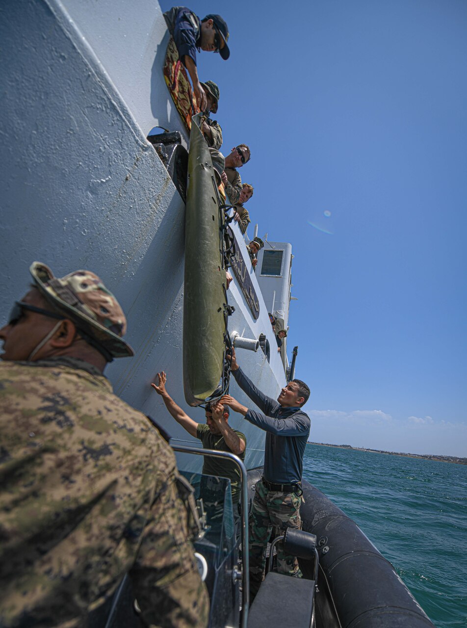 U.S. Marines, assigned to Task Force 61 Naval Amphibious Forces Europe/ 2d Marine Division (TF-61/2), and members of the Tunisian 51st Regiment Commando Maritime practice hoisting drills on the Tunisian NRF Khaireddine (A 700) during exercise Phoenix Express 2022 in Bizerte, Tunisia, May 24, 2022.