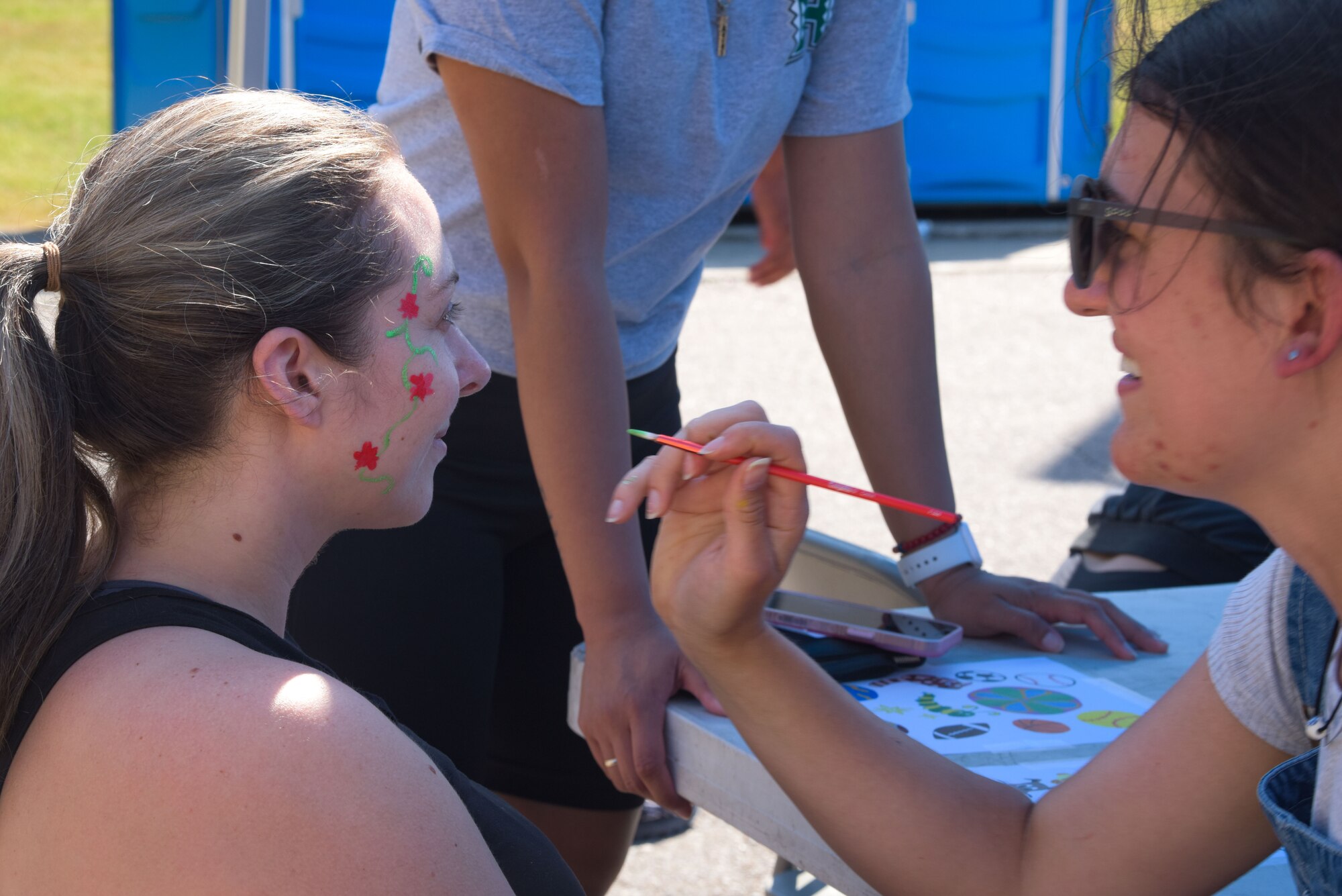 An attendee gets her face painted by a volunteer during the Memorial Day Bash at Osan Air Base, Republic of Korea, May 26, 2022.
