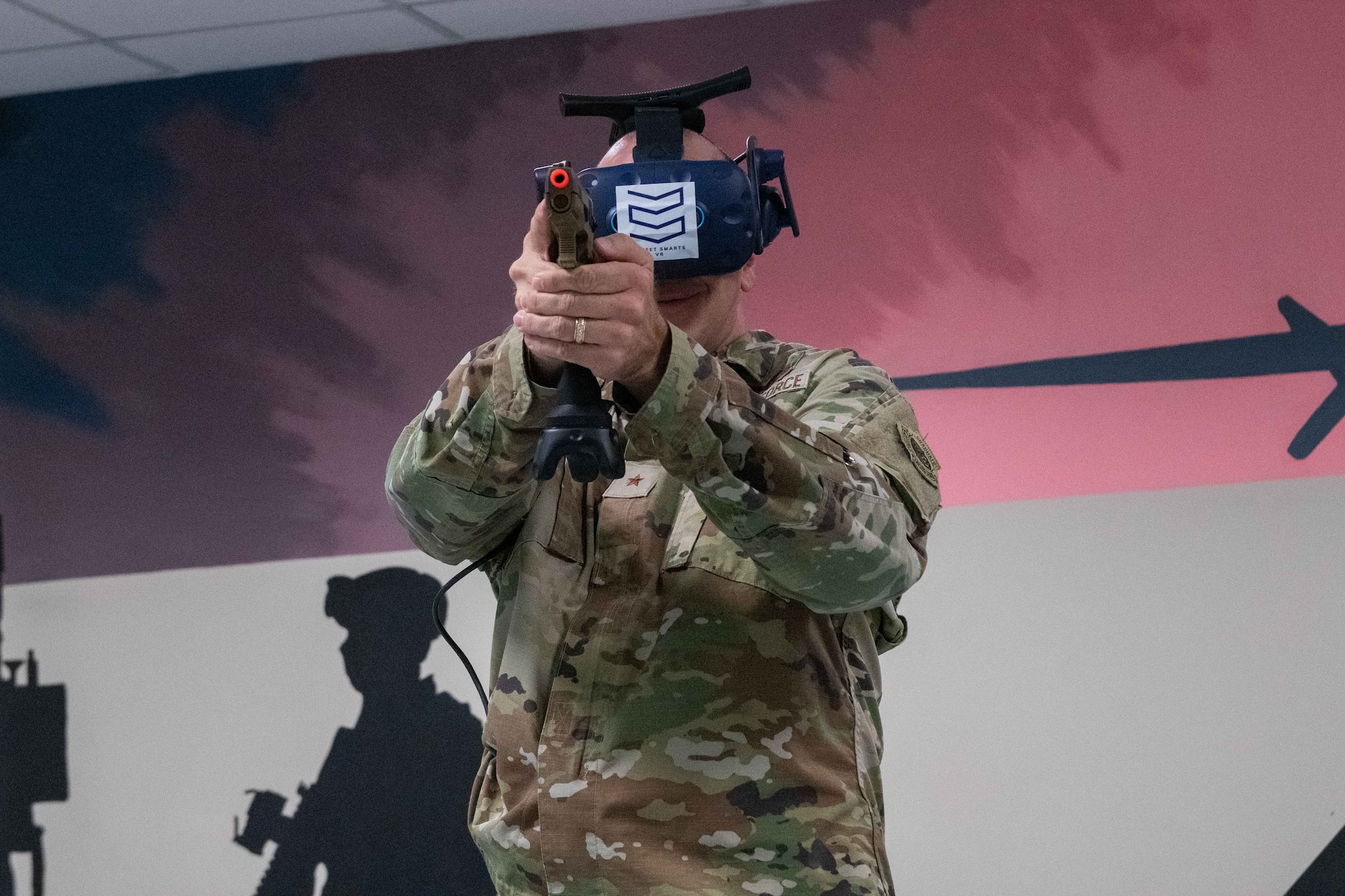 U.S. Air Force Brig. Gen. Gerald Donohue, 379th Air Expeditionary Wing Commander, practices a training simulation through virtual reality on Al Udeid Air Base, Qatar, May 24, 2022. The Street Smart VR Simulator allows airmen to simulate scenarios that they may face in real life. (U.S. Air National Guard photo by Airman 1st Class Constantine Bambakidis)