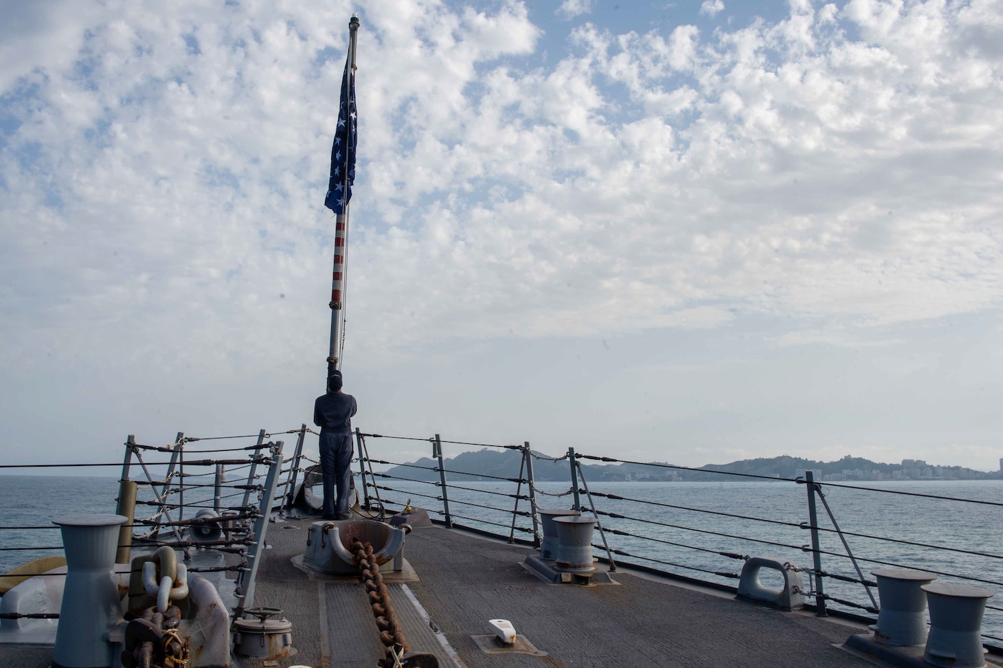 Logistics Specialist 3rd Class Matthew Haggerty, from Wayngott, Michigan, raises the Union Jack during morning colors aboard the Arleigh Burke-class guided-missile destroyer USS Jason Dunham (DDG 109), while anchored for a port visit in Durres, Albania, May 29, 2022.