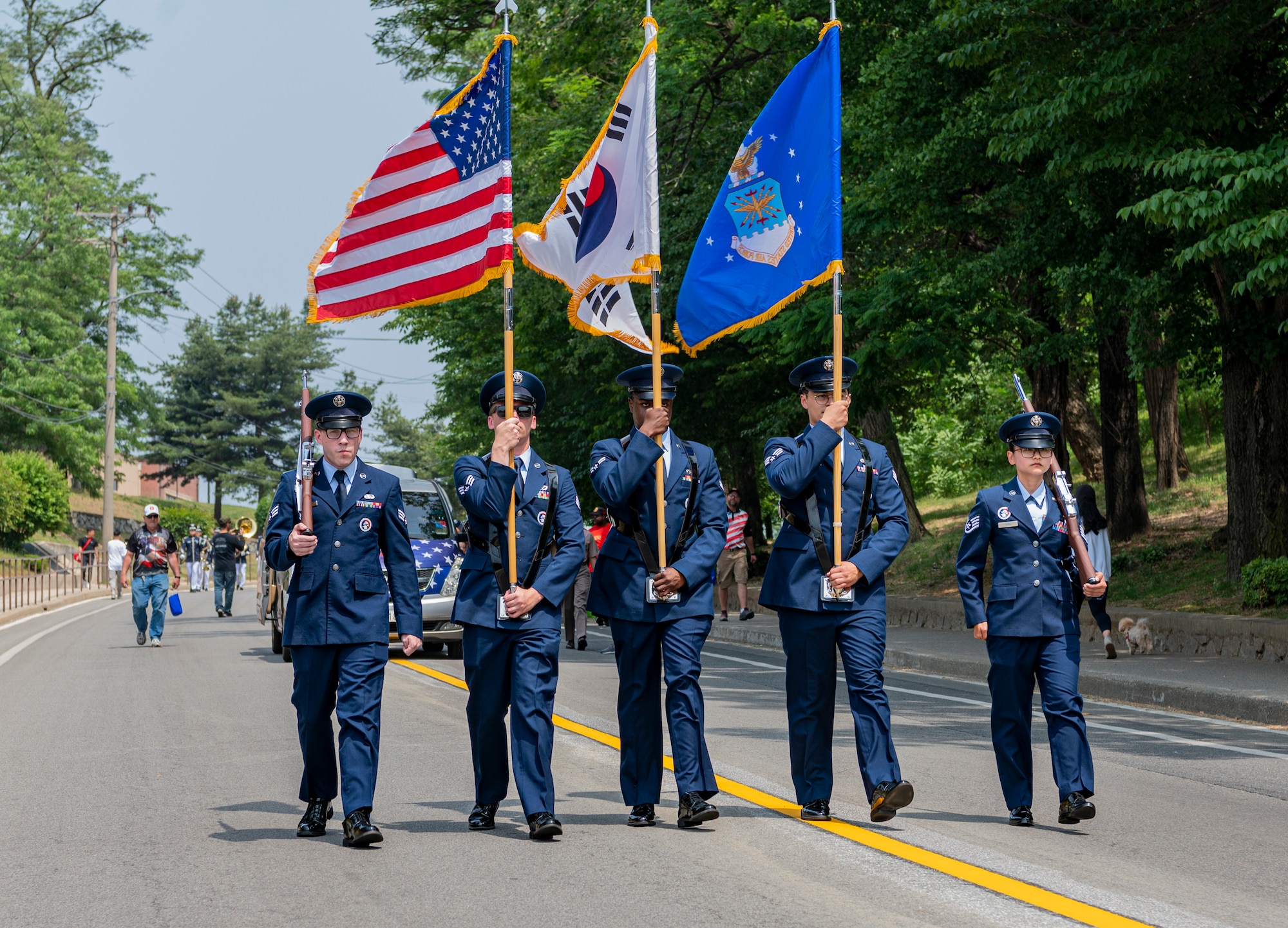 U.S. Air Force Honor Guard members march down a street during the Armed Forces Day Parade .