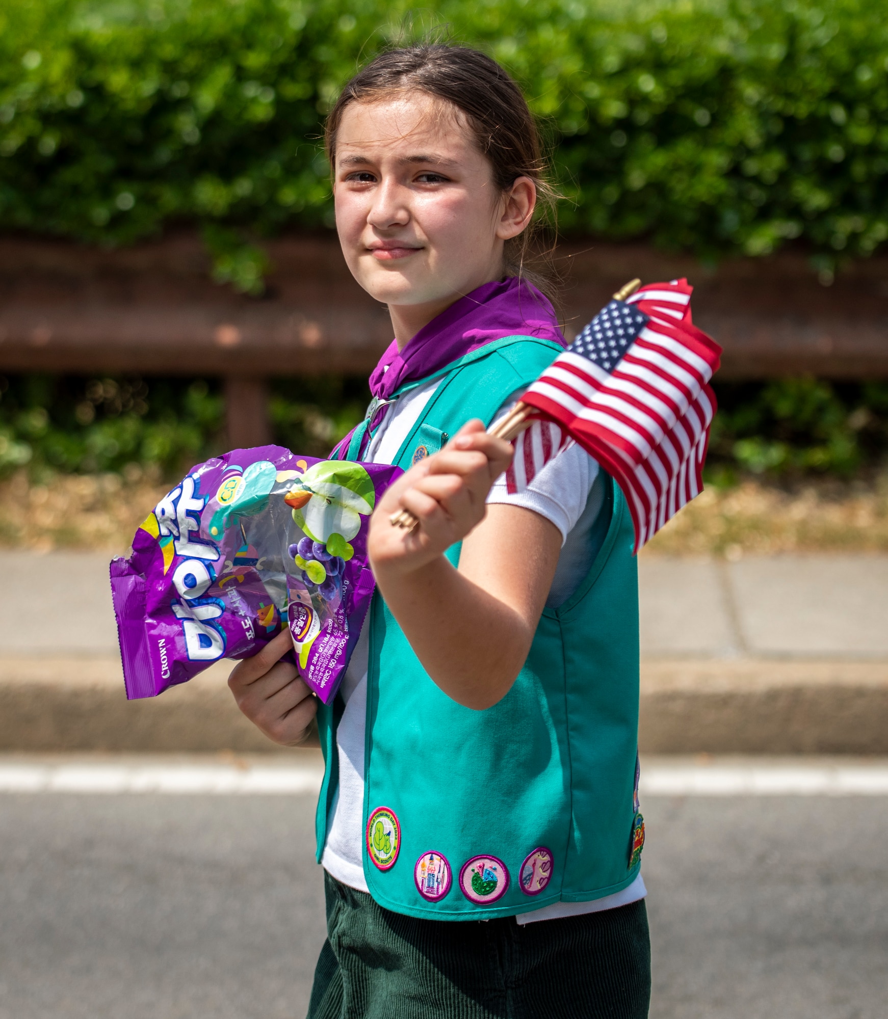 An Osan Girl Scout member waves the American flag during the Armed Forces Day Parade