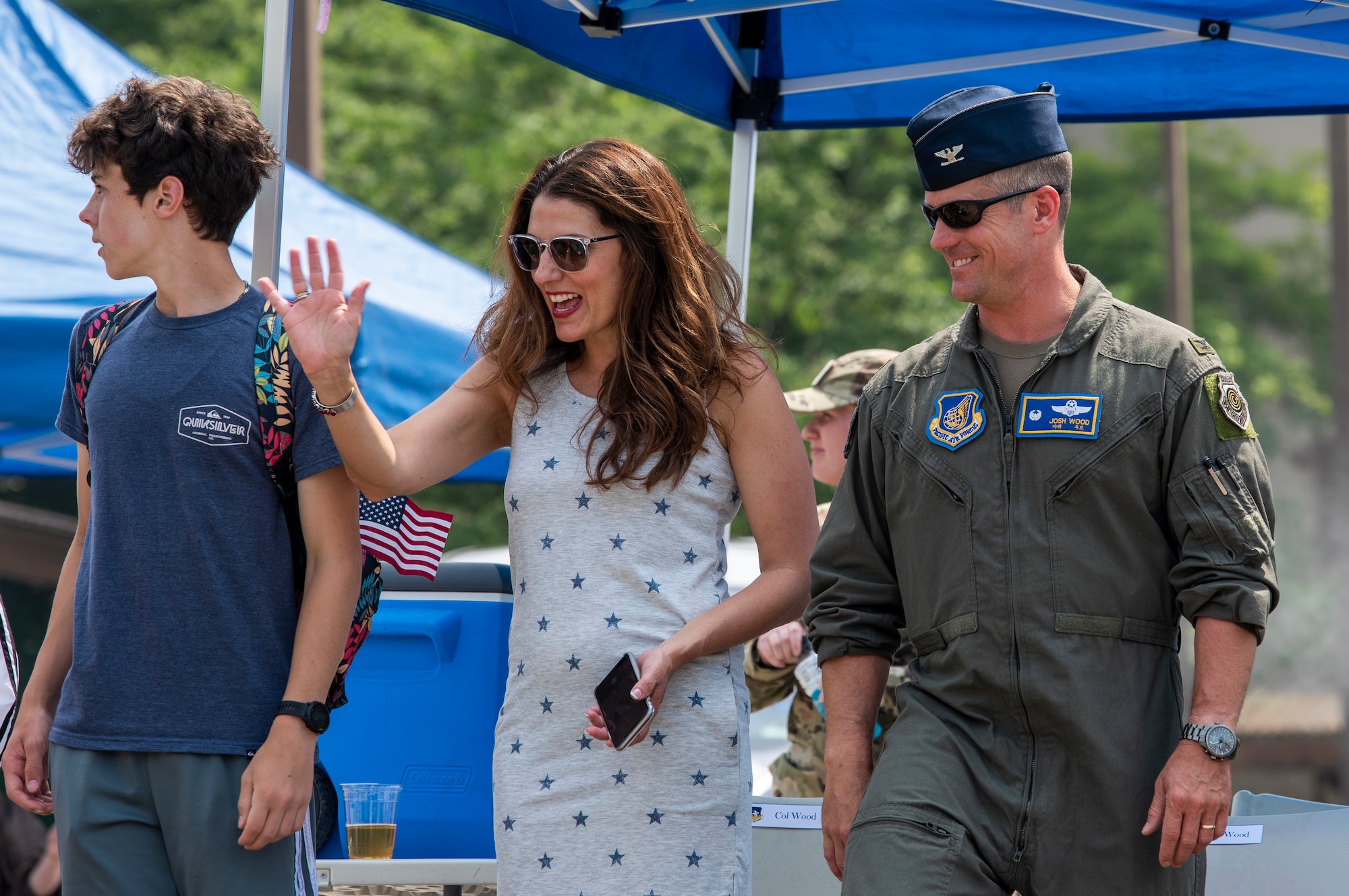 Col. Joshua Wood, 51st Fighter Wing commander, wife Bonnie and son stand  during a parade.