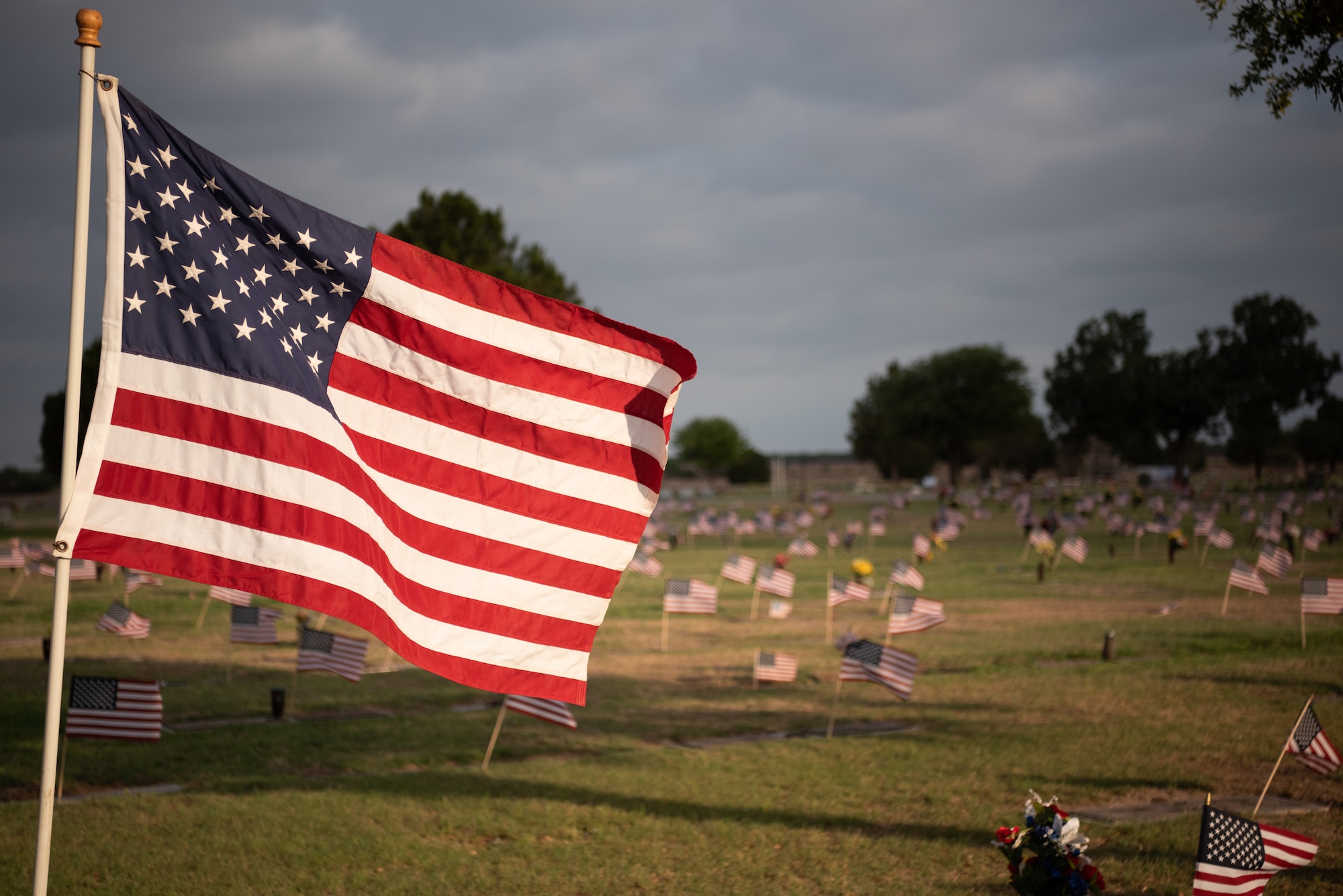 The Star Spangled Banner waves in the wind at Lawnhaven Memorial Gardens, San Angelo, Texas, May 30, 2022. Lawnhaven was the site of a Memorial Day ceremony where members of Goodfellow Air Force Base and the San Angelo community came together to remember our fallen heroes. (U.S. Air Force photo by Senior Airman Michael Bowman)