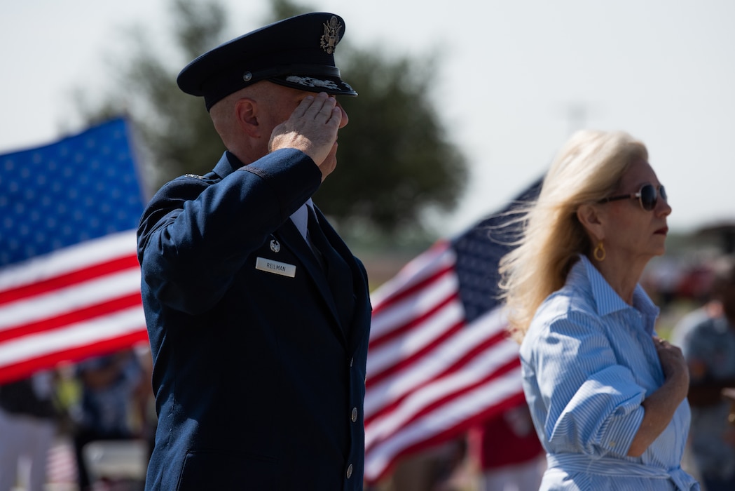 U.S. Air Force Col. Matthew Reilman, 17th Training Wing commander, (left) and Brenda Gunther, City of San Angelo mayor (right) render the proper customs and courtesies as the American flag is raised during a Memorial Day service at Lawnhaven Memorial Gardens, San Angelo, Texas, May 30, 2022. Memorial Day was established in 1868 by Commander in Chief John A. Logan of the Grand Army of the Republic.  (U.S. Air Force photo by Senior Airman Michael Bowman)