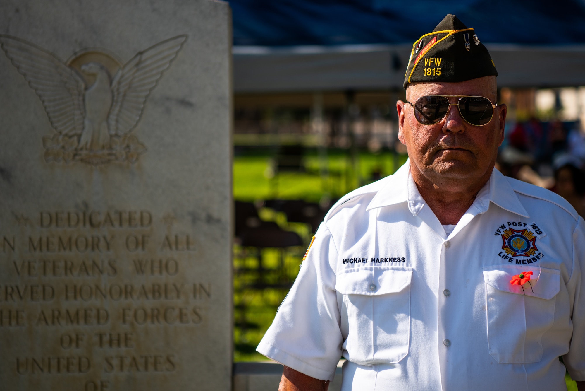 U.S. Army Staff Sergeant (retired) Michael Harkness, airborne ranger, stands in front of the veterans memorial during a Memorial Day service at the Tom Green County Courthouse Lawn, San Angelo, Texas, May 30, 2022. Harkness is currently acting as the junior vice commander of Veterans of Foreign Wars Post 1815. (U.S. Air Force photo by Senior Airman Michael Bowman)