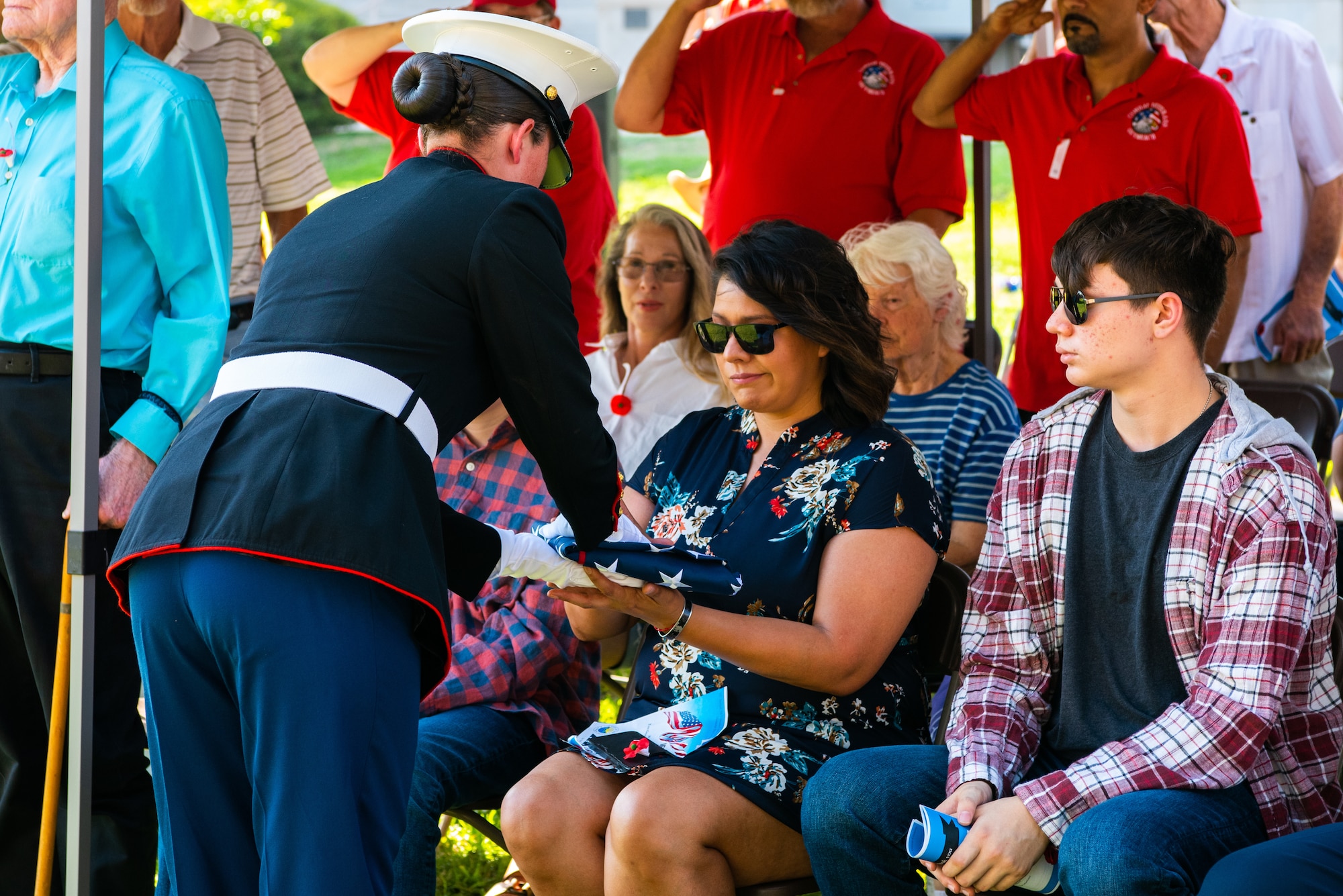U.S. Marine Corps Private Jessica Garner, Marine Corps Detachment Goodfellow student, presents the American flag to Mrs. Janet Worden, gold star spouse, during a Memorial Day service San Angelo, Texas, May 30, 2022. U.S. Army Sergeant Norman Alexander Worden is survived by his wife and two sons.  (U.S. Air Force photo by Senior Airman Michael Bowman)