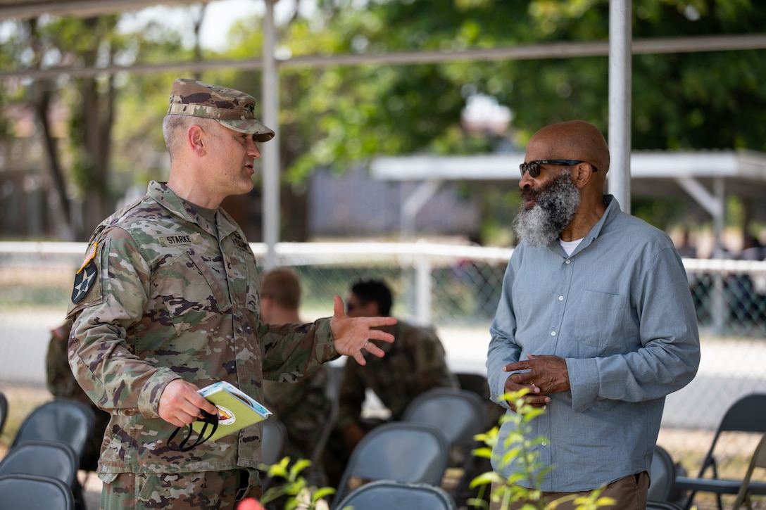 Kentucky National Guard Col. Timothy Starke, brigade commander of the 75th Troop Command, speaks with Mr. Glenn Cheatham, lead planner from U.S. Coast Guard Atlantic Area, before the closing ceremonies of Operation Tradewinds 22 at Price Barracks, Belize on May 20, 2022. Tradewinds 2022 is a multinational exercise designed to expand the Caribbean region’s capability to mitigate, plan for, and respond to crises; increase regional training capacity and interoperability; develop new and refine existing standard operating procedures (SOPs); enhance ability to defend exclusive economic zones (EEZ); and promote human rights and adherence to shared international norms and values; fully integrate women into defense, peace and security missions; and increase maritime domain awareness to deter illegal, unregulated and unreported fishing activities (U.S. Army photo by Staff Sgt. Andrew Dickson).
