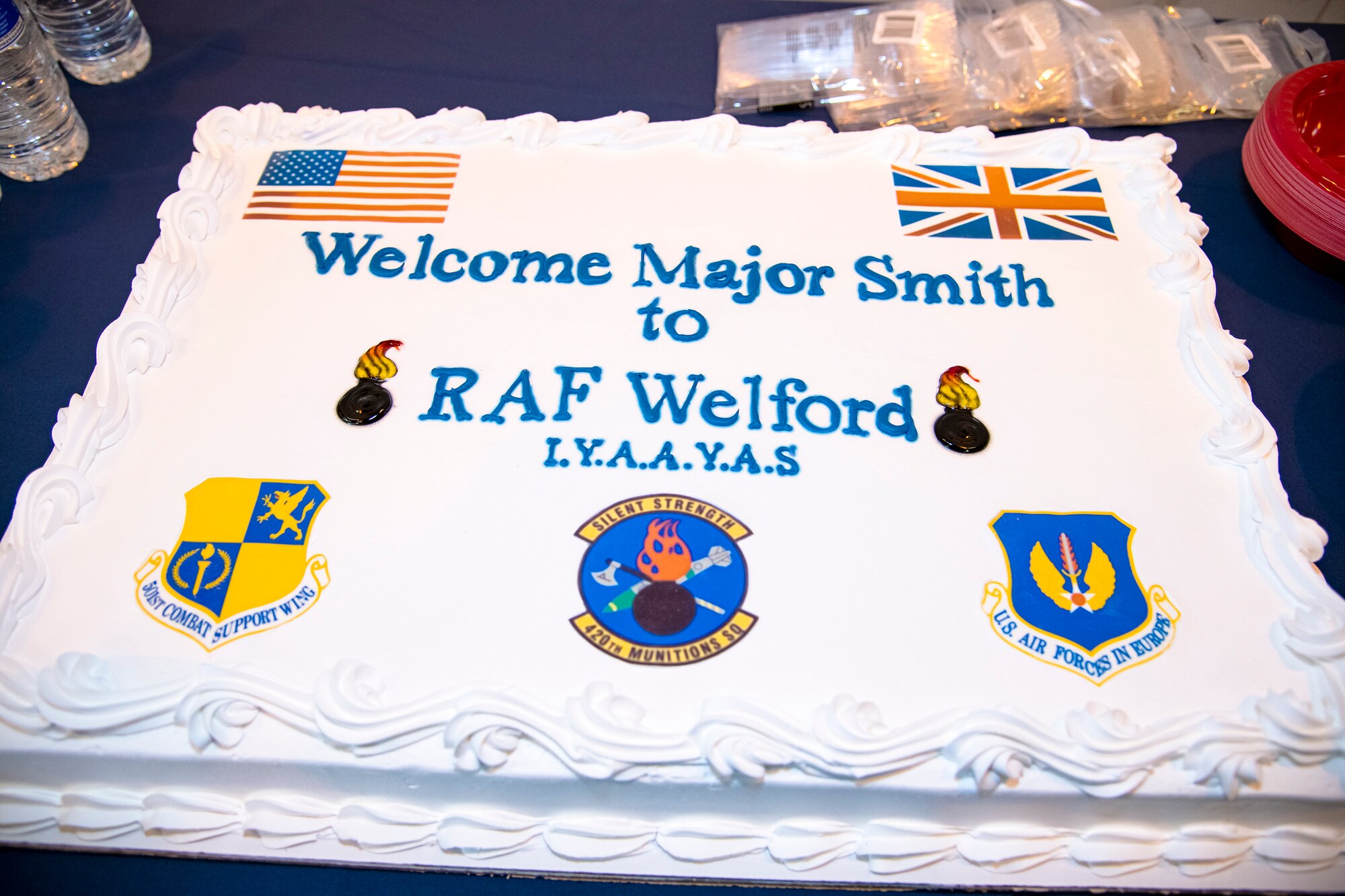 A cake welcoming Maj. Preston Smith, 420th Munitions Squadron incoming commander, rests on a table prior to a change of command ceremony at RAF Welford, England, May 26, 2022. Prior to assuming command of the 420th MUNS, Smith served as the director of operations for the 509th Maintenance Squadron, Whiteman Air Force Base, Missouri. (U.S. Air Force photo by Staff Sgt. Eugene Oliver)