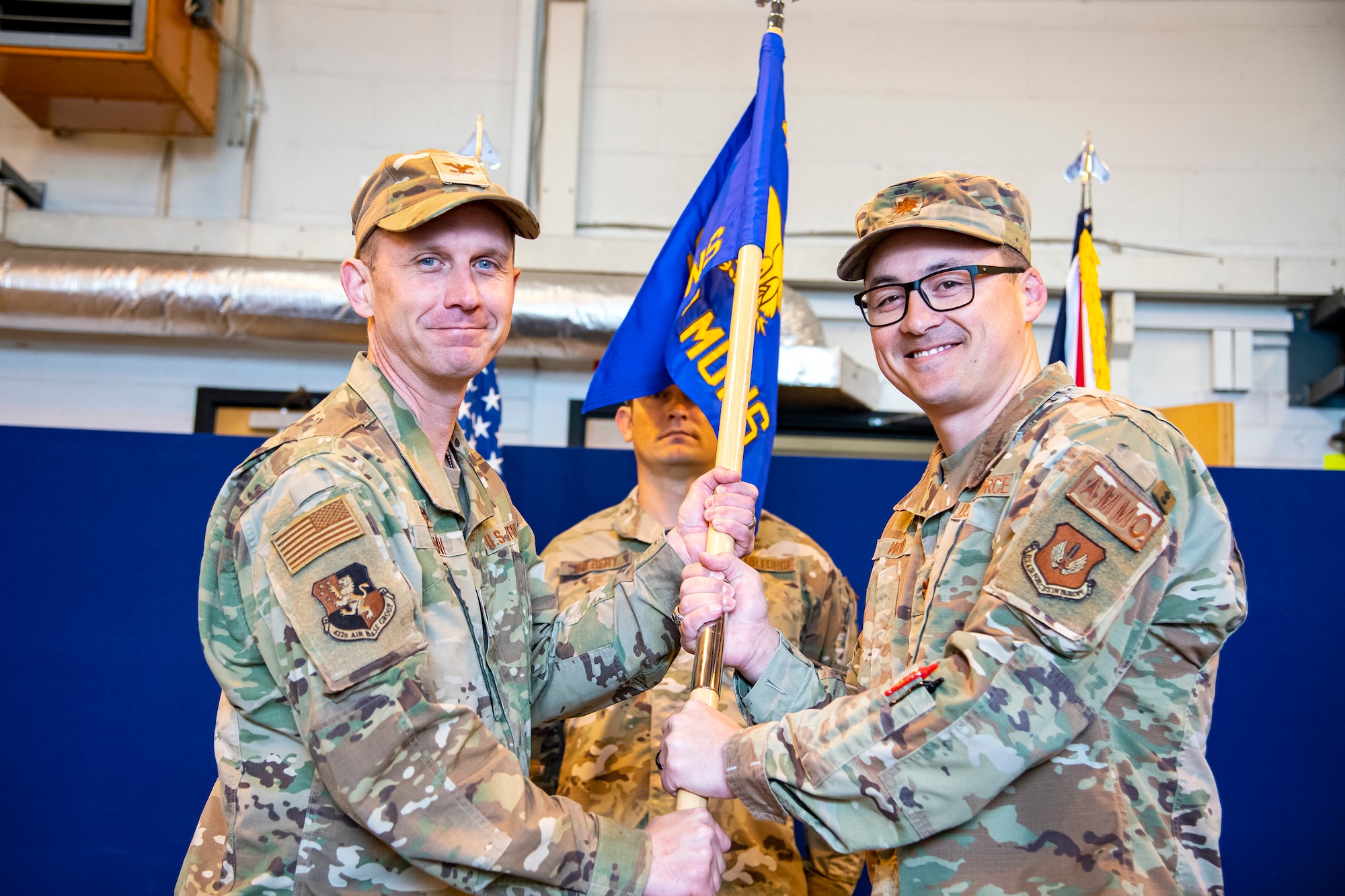 U.S. Air Force Jon T. Hannah, left, 422d Air Base Group commander, receives the 420th Munitions Squadron guidon from Maj. Christopher Wood, 420th Munitions Squadron outgoing commander, during a change of command ceremony at RAF Welford, England,  May 26, 2022. During his command Wood was responsible for all munitions operations maintaining USAFE’s second largest weapons stockpile valued at $403 million in war reserve material. (U.S. Air Force photo by Staff Sgt. Eugene Oliver)