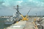 A guided missile destroyer is loaded with munitions at the Naval Weapons Station Seal Beach wharf.