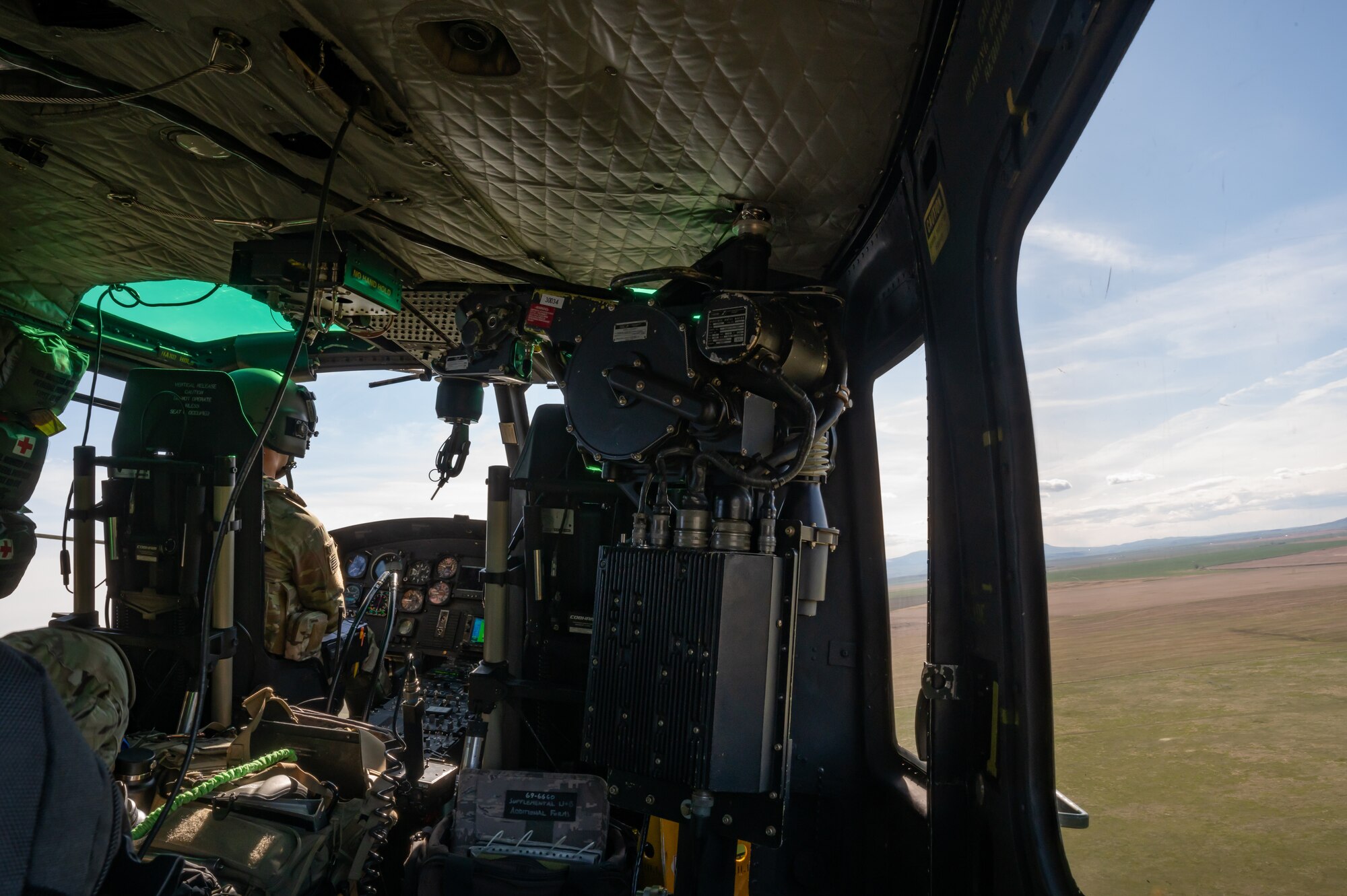 Capt. Scott Rumsey, 40th Helicopter Squadron pilot, performs co-pilot duties inside a UH-1N Huey helicopter May 24, 2022, over the Highwood Mountains near Great Falls, Mont.