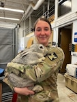Minnesota National Guard Spc. Asia Enger holds a giant rabbit near Kodiak, Alaska, where 43 Guard members with the 204th Medical Company Area Support Company mobilized in early May to support Arctic Care 2022.