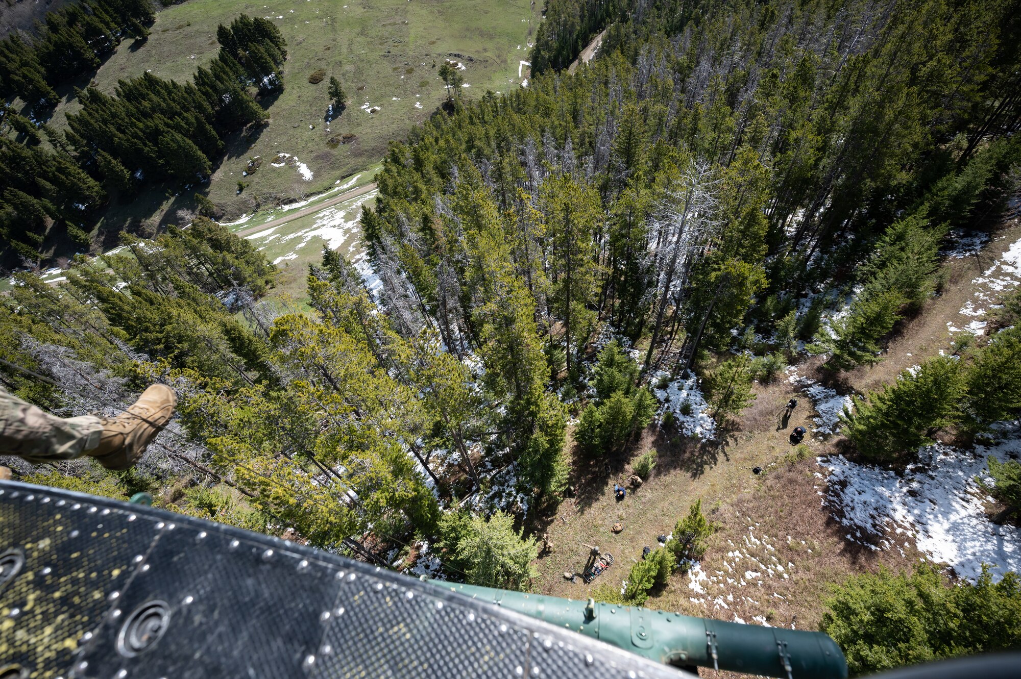 Members of the 40th Helicopter Squadron and 341st Missile Wing prepare to hoist a simulated patient onto a UH-1N Huey helicopter during a search and rescue exercise May 24, 2022, in the Highwood Mountains near Great Falls, Mont.