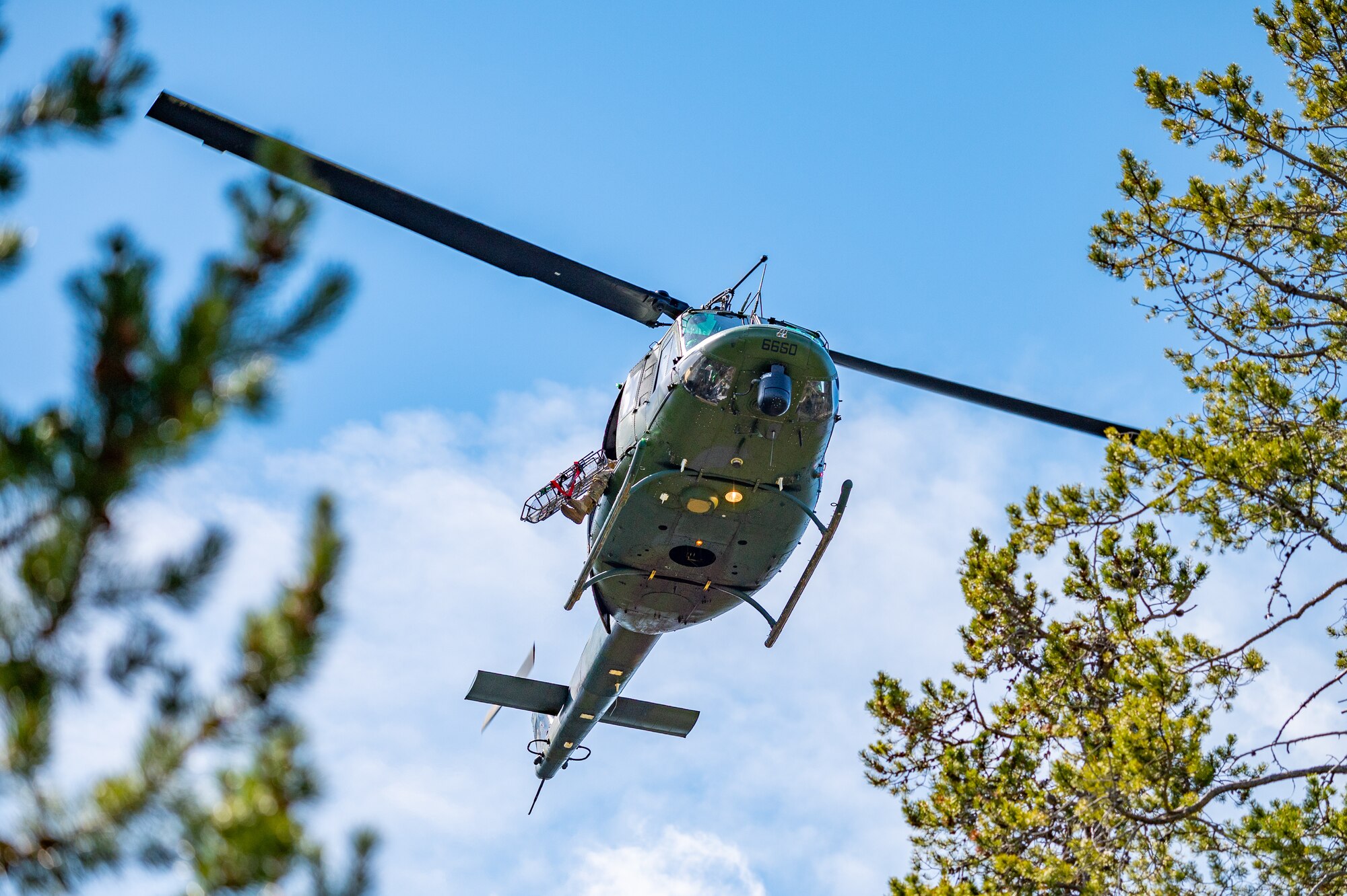 A UH-N1 Huey from the 40th Helicopter Squadron makes its way to the location of an injured hiker during a search and rescue exercise May 24, 2022, over the Highwood Mountains near Great Falls, Mont.