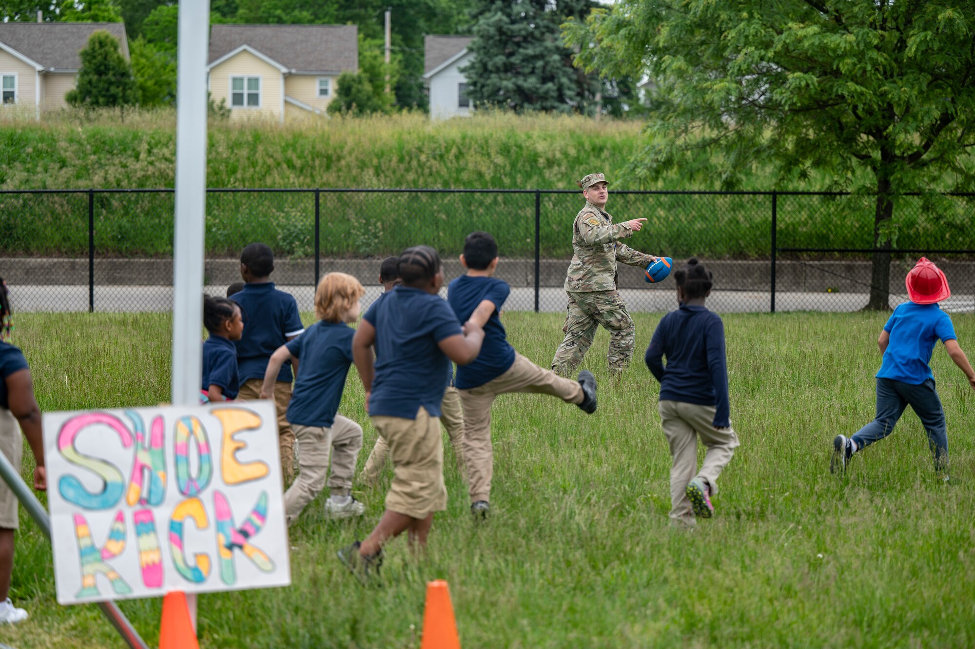 U.S. Air Force Capt. Tyler Wallis, a volunteer from the Air Force Life Cycle Management Center Special Programs Division, runs a shoe toss event during a field day to mark the end of the school year at Edison Elementary School May 25, 2022. Members of the Special Programs Division helped host the field day by setting up and running outdoor activities for the students to enjoy on their last day of school. (U.S. Air Force photo by Tech. Sgt. Matthew B. Fredericks)