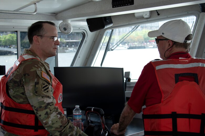 SAVANNAH, Ga. – Col. Geoff Bailey, left, the U.S. Army Corps of Engineers chaplain, speaks with Burt Moore aboard the SV Holland while touring the Savannah River in Savannah, Georgia on May 18.