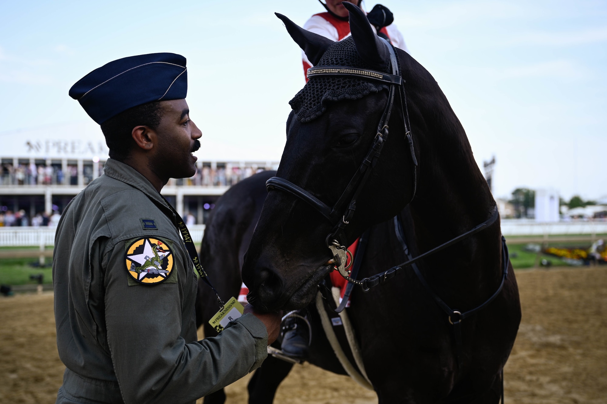 A U.S. Air Force B-2 Spirit pilot meets one of the working horses during the Preakness at the Pimlico race course, Baltimore, Maryland, May 21, 2022. The Preakness Stakes is an American thoroughbred horse race held on the third Saturday in May each year in Baltimore, Maryland.