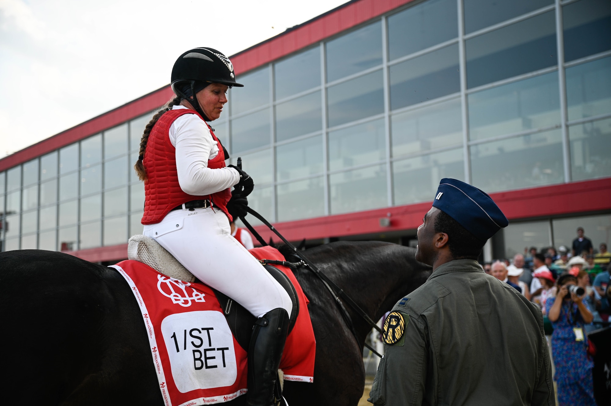 A U.S. Air Force B-2 Spirit pilot talks to Preakness Stakes attendees at the Pimlico race course, Baltimore, Maryland, May 21, 2022. The Preakness Stakes is an American thoroughbred horse race held on the third Saturday in May each year in Baltimore, Maryland.