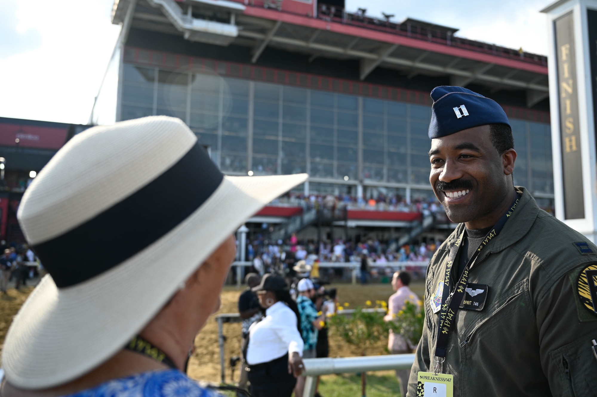 A U.S. Air Force B-2 Spirit pilot talks to Preakness Stakes attendees at the Pimlico race course, Baltimore, Maryland, May 21, 2022. The Preakness Stakes is an American thoroughbred horse race held on the third Saturday in May each year in Baltimore, Maryland.