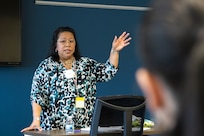 Adele Borders, U.S. Army Financial Management Command Military Pay Operations branch manager, speaks to USAFMCOM Army Military Pay Office directors and supervisors during an AMPO leadership forum at the Maj. Gen. Emmett J. Bean Federal Center in Indianapolis May 12, 2022. Throughout the three-day forum, subject matter experts from USAFMCOM, the Defense Finance and Accounting Service, and other U.S. Army organizations covered a variety of topics including military pay operations, human resources, debt and claims, SmartVoucher for permanent change of station moves, fraud, ethics, and Army-specific functions. (U.S. Army photo illustration by Mark R. W. Orders-Woempner)