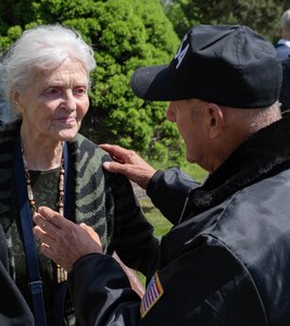 President of the C-54 flight crew group in Utah speaks to Ingrid Azvedo, a child survivor of Berlin, during the wreath-laying at Gail Halvorsen on May 20, 2022.