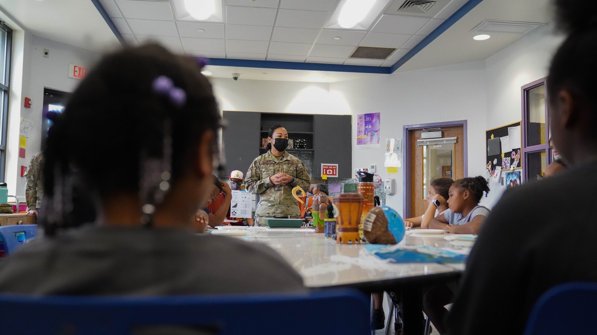 U.S. Air Force Maj. Michelle Rosaleas, 81st Operational Medical Readiness Squadron public health flight chief, talks to children about Asian American and Pacific Islander culture at the Youth Center on Keesler Air Force Base, Mississippi, May 26, 2022. The AAPI Heritage Month committee hosted a craft event to introduce children to AAPI traditions and heritage. (U.S. Air Force photo by Airman 1st Class Elizabeth Davis)