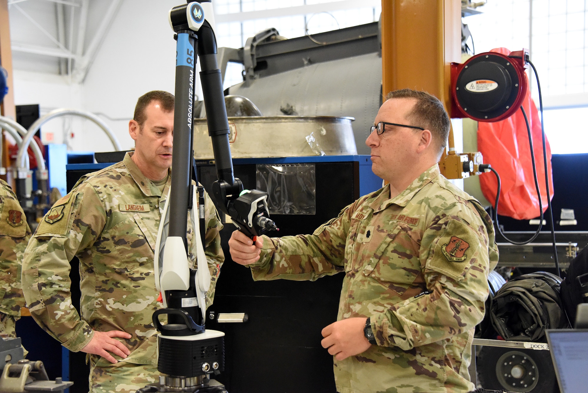 Photo of Portable coordinate measuring arm technology being demonstrated.
