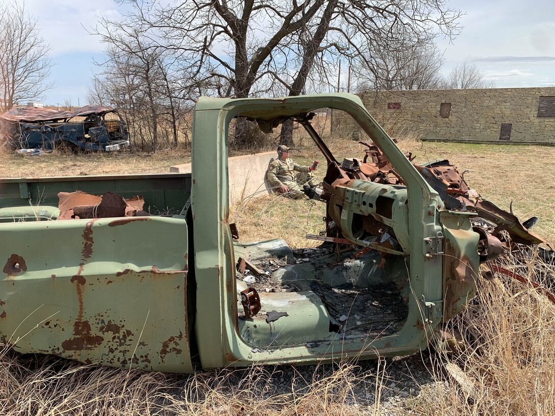U.S. Air Force Staff Sgt. Mark Cantarero, a 97th Security Forces Squadron unit trainer and evaluator from Altus Air Force Base (AFB), Oklahoma, prepares to set off the machine gun simulator to imitate automatic weapons fire while training Airmen from the 507th Civil Engineering Squadron (CES) PRIME BEEF training at Fort Sill, Oklahoma, April 1, 2022. Cantarero helped the 507th CES Airmen from Tinker AFB, Oklahoma, practice reaction to contact during field patrolling. (Courtesy photo)