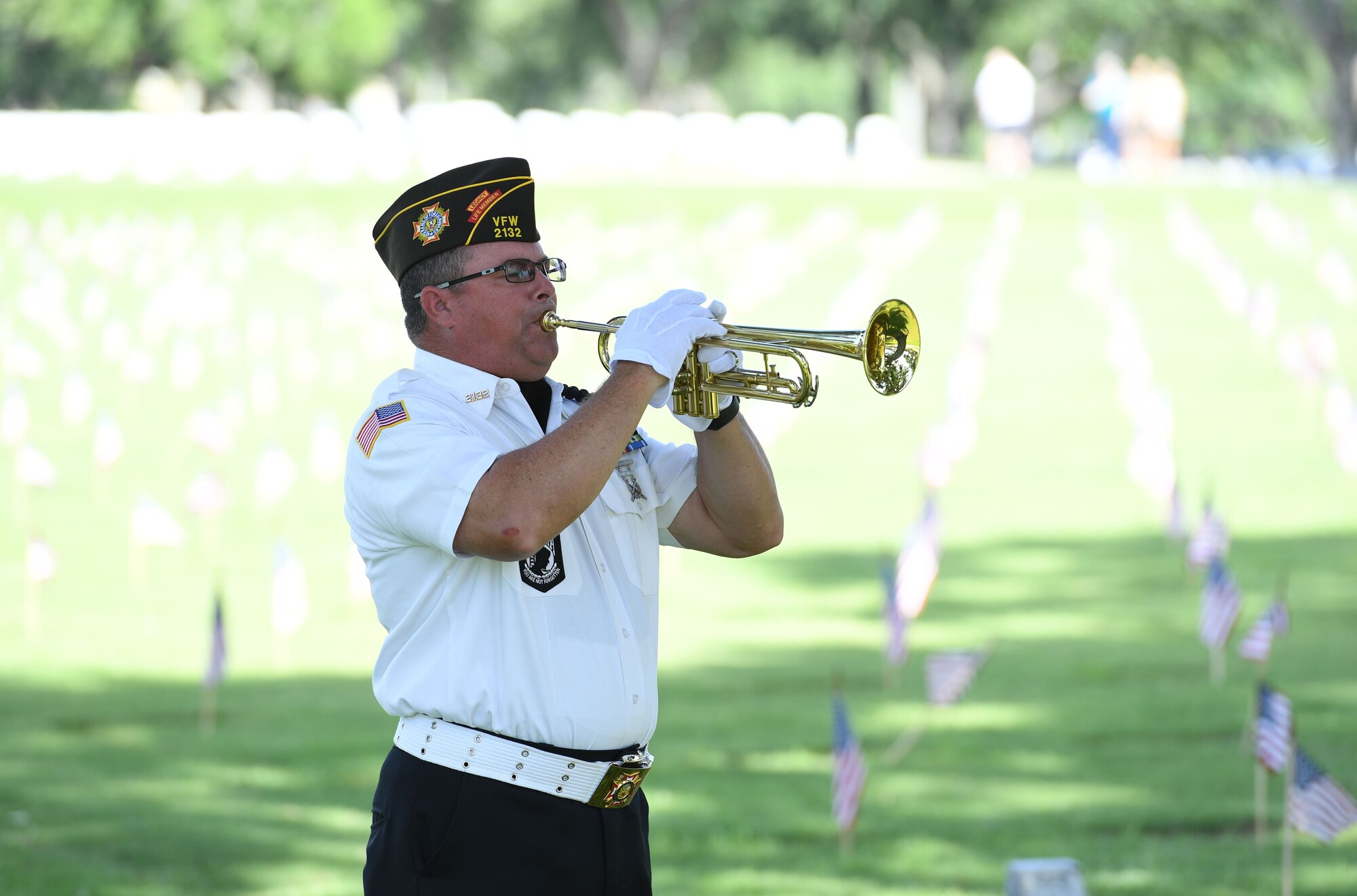 Stephan Trochessett, Post 2132 Honor Guard member, plays Taps during the Biloxi National Cemetery Memorial Day Ceremony in Biloxi, Mississippi, May 30, 2022. The ceremony honored those who have made the ultimate sacrifice while serving in the armed forces. Biloxi National Cemetery is the final resting place of more than 23,000 veterans and their family members. Every year, 800 burials take place there for men and women who served in wars years ago and for those defending America today. (U.S. Air Force photo by Kemberly Groue)