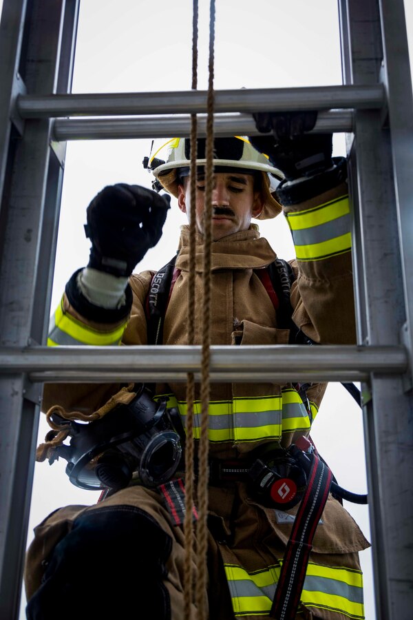 U.S. Marine Corps Sgt. Terrence Moran, a systems chief operator with Headquarters and Headquarters Squadron, Marine Corps Air Station Futenma, Marine Corps Installations Pacific, climbs a ladder during a firefighter Physical Ability Test on Marine Corps Air Station Futenma, Okinawa, Japan, May 4, 2022. The firefighters’ Physical Ability Test is a tool used to measure how effective a Marine is while performing multiple tasks over a set period. The test consists of 10 tasks that evaluate cardiovascular and strength performance. (U.S. Marine Corps photo by Lance Cpl. Jonathan Beauchamp)