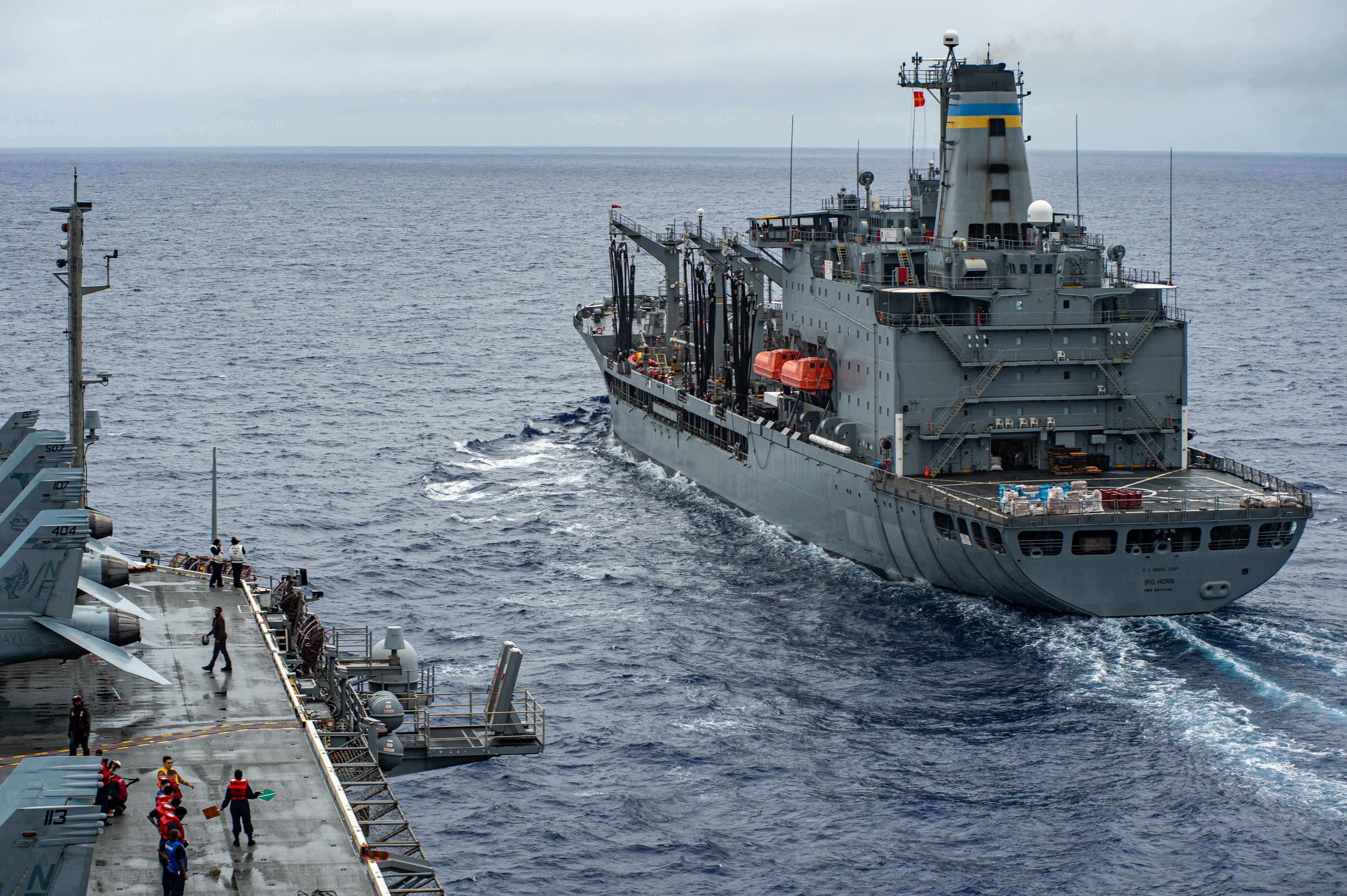 The U.S. Navy's only forward-deployed aircraft carrier USS Ronald Reagan (CVN 76), approaches the Military Sealift Command Henry J. Kaiser-class replenishment oiler USNS Big Horn (T-AO 198) in preparation for a replenishment-at-sea. During the evolution, Big Horn transported fuel and cargo to Ronald Reagan via connected replenishment.