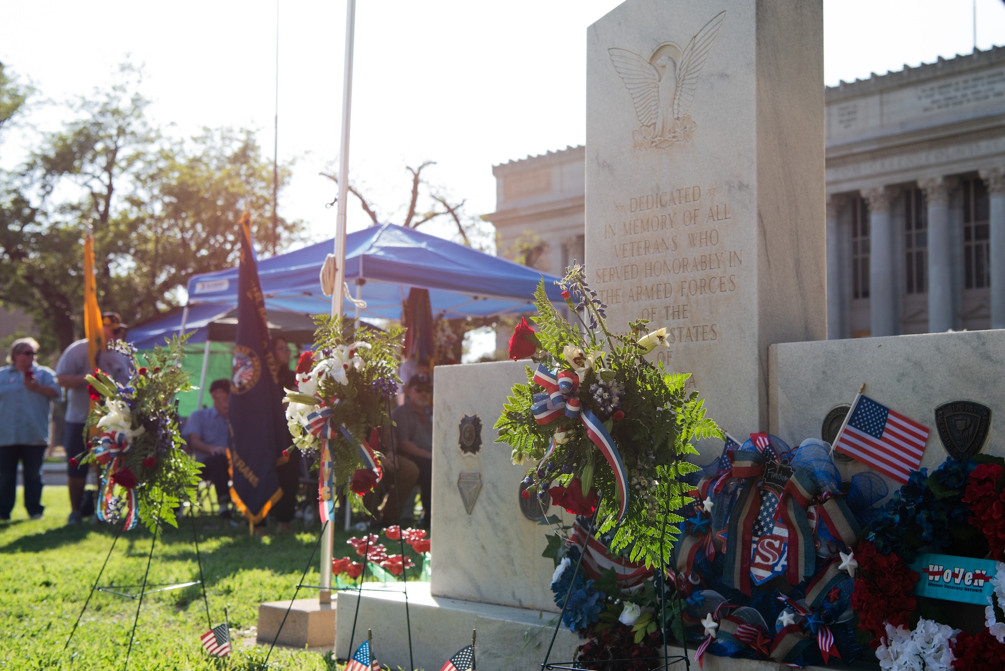 Wreaths are placed in front of the American Veterans Center Monument during a Memorial Day service at the Tom Green County Courthouse Lawn, San Angelo, Texas, May 30, 2022. Memorial Day is a time to honor the service and sacrifice of the Soldiers, Sailors, Airmen, Marines, Guardians, and Coast Guardsmen that gave their lives in defense of the United States. (U.S. Air Force photo by Senior Airman Michael Bowman)