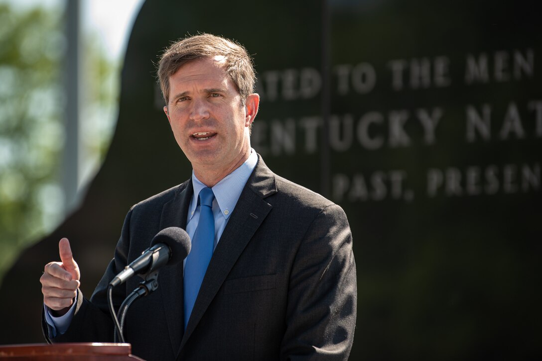 Kentucky Gov. Andy Beshear speaks to the audience at a memorial service held in Frankfort, Ky., May 30, 2022, honoring members of the Kentucky National Guard who have died in the line of duty. The names of 13 Soldiers were added to the Kentucky National Guard Memorial at Boone National Guard Center this year, bringing the total number of fallen Airmen and Soldiers to 286. (U.S. Air National Guard photo by Dale Greer)