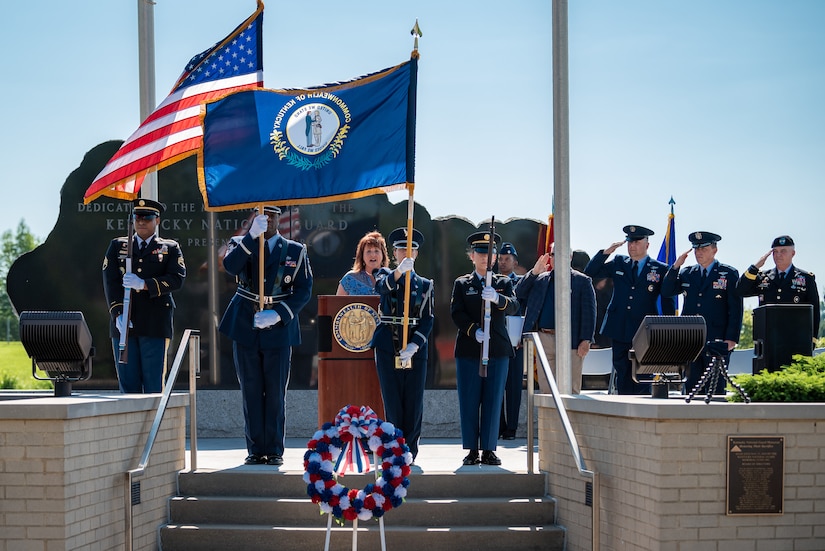 A joint color guard from the Kentucky Army and Air National Guard present the colors while April Brown, a retired lieutenant colonel, sings the National Anthem at a memorial service held in Frankfort, Ky., May 30, 2022, honoring members of the Kentucky National Guard who have died in the line of duty. The names of 13 Soldiers were added to the Kentucky National Guard Memorial at Boone National Guard Center this year, bringing the total number of fallen Airmen and Soldiers to 286. (U.S. Air National Guard photo by Dale Greer)