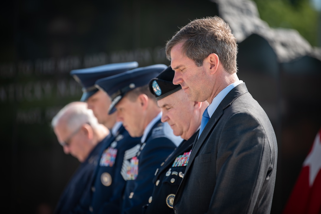 Kentucky Gov. Andy Beshear joins the leaders of the Kentucky National Guard in prayer at a memorial service held in Frankfort, Ky., May 30, 2022, honoring members of the Kentucky Guard who have died in the line of duty. The names of 13 Soldiers were added to the Kentucky National Guard Memorial at Boone National Guard Center this year, bringing the total number of fallen Airmen and Soldiers to 286. (U.S. Air National Guard photo by Dale Greer)