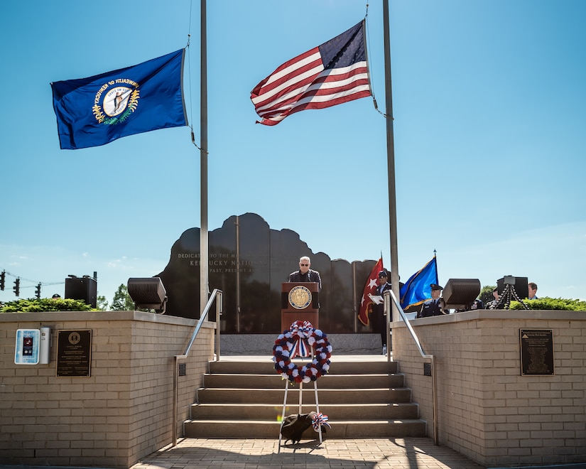 Army Brig. Gen. Benjamin F. Adams III (retired), former assistant adjutant general for Army and chairman of the Kentucky National Guard Memorial Fund Inc. reads the names of 13 fallen Soldiers who were added to the memorial this year during a ceremony at Boone National Guard Center in Frankfort, Ky., May 30, 2022. Of the 13 names being added, 11 were killed during World War I, one in 1935 during weekend training, and another in 2001 just prior to 9/11. The monument now honors 286 Solders and Airmen from the Kentucky Guard who have paid the ultimate price for freedom since 1912. (U.S. Air National Guard photo by Dale Greer)